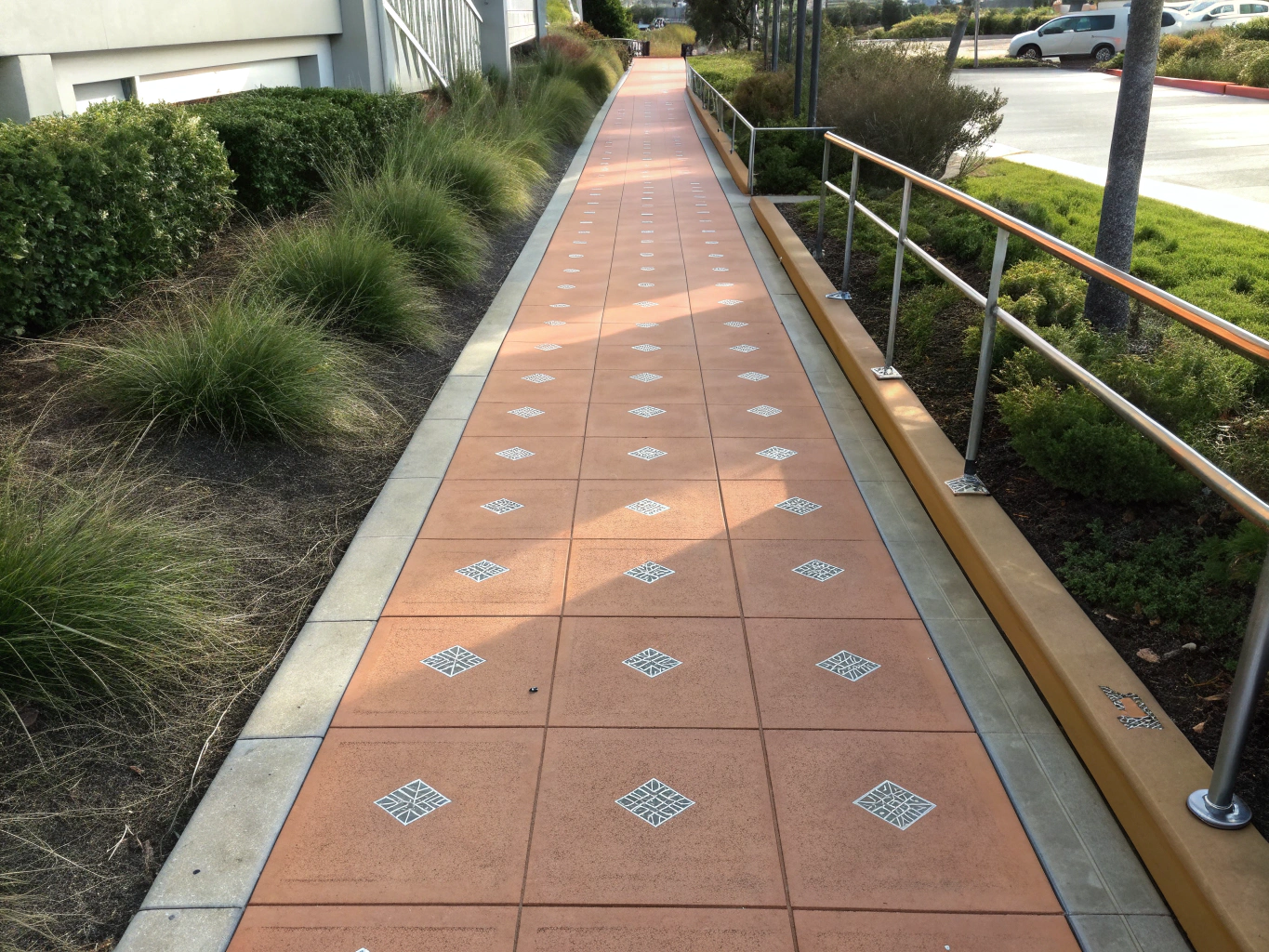 Artisan stained decorative concrete walkway with precision borders